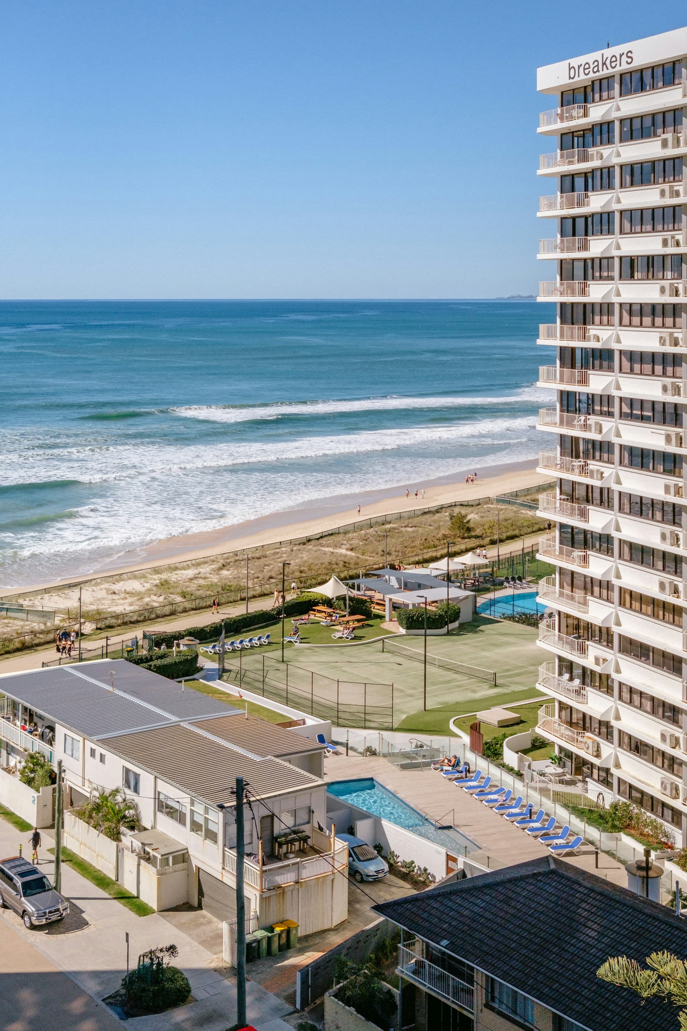 Beachfront accommodation, swimming pools and sun loungers beside the Gold Coast surf
